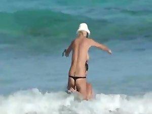 Skinny topless girl enters the water Picture 5