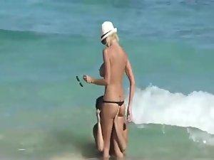 Skinny topless girl enters the water Picture 6