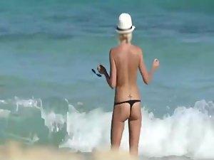 Skinny topless girl enters the water Picture 8