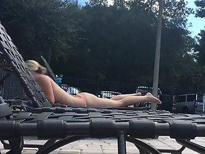 Amazing blonde sunbathes by the swimming pool Picture 1