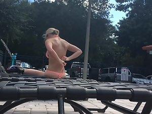Amazing blonde sunbathes by the swimming pool Picture 2
