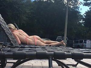 Amazing blonde sunbathes by the swimming pool Picture 3