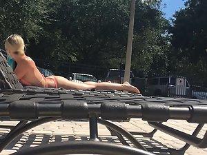 Amazing blonde sunbathes by the swimming pool Picture 4