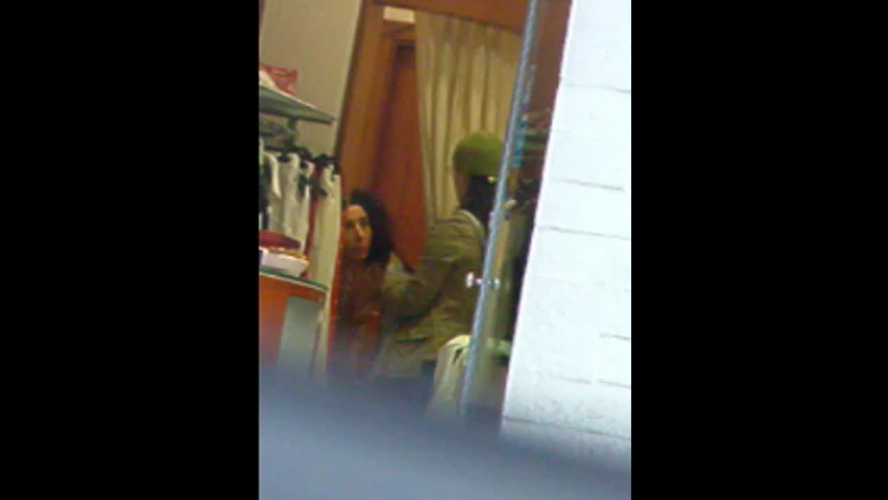 Half naked friend peeks out of dressing room