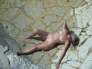 Mature nudist beach lying on the rocks Picture 2