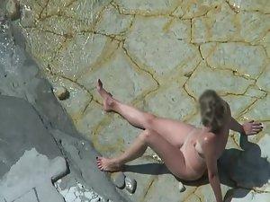 Mature nudist beach lying on the rocks Picture 7