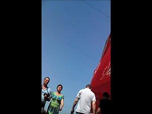 Candid camera in upskirt while she checks what street vendor got Picture 1