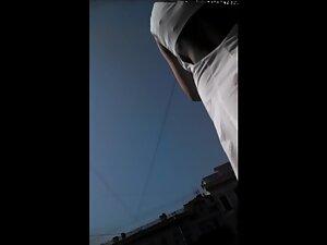 Candid camera in upskirt while she checks what street vendor got Picture 8