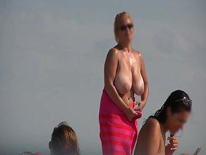Gigantic mature tits on a beach Picture 5