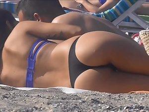Checking her tight buttocks while she cuddles on beach Picture 5