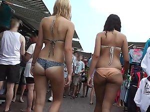 Peachy butt in bikini walks through marketplace Picture 1