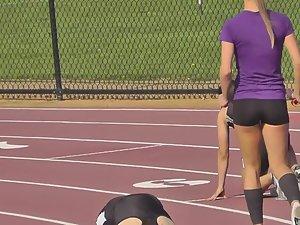 Runner girl bends over to stretch Picture 1