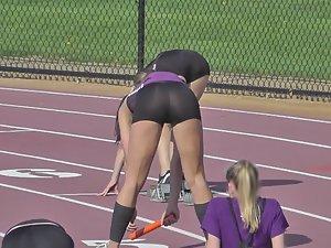 Runner girl bends over to stretch