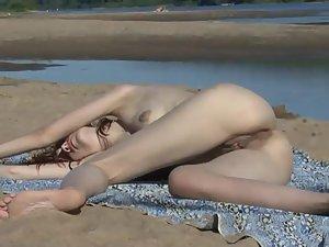 Silly nude girl lying down on a beach Picture 3