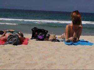 Topless girl gets up carelessly after suntanning Picture 2