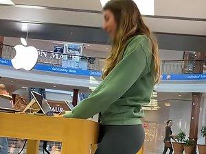 Breathtaking girl bends over a tall desk