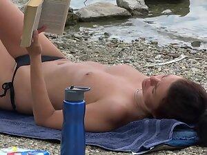 Topless hottie reading a book on the beach