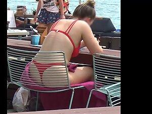 Bubble butt in red bikini is visible through the chair on the beach Picture 6
