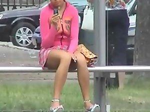 Sneaky peep of a bored girl on a bus stop Picture 1