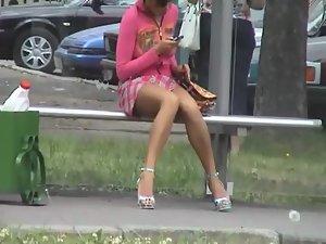 Sneaky peep of a bored girl on a bus stop Picture 2