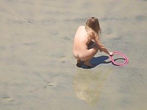 Hot nudist girl plays catch on the beach Picture 3