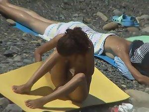 Nudist girl does yoga on the beach Picture 4