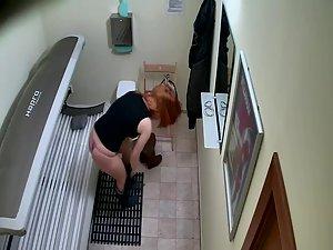 Redhead girl lies down in a tanning bed Picture 4