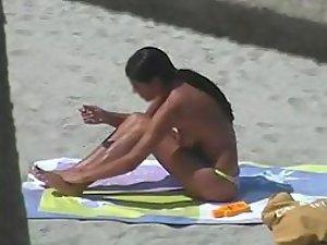 Spying a tanned topless babe Picture 1