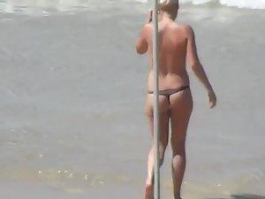 Topless beach babe in a thong bikini Picture 2