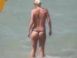 Topless beach babe in a thong bikini Picture 3