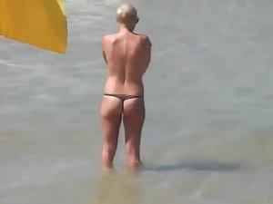 Topless beach babe in a thong bikini Picture 5