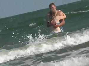 White bikini outlines her butt while she is in the waves Picture 3
