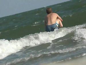 White bikini outlines her butt while she is in the waves Picture 6