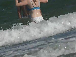 White bikini outlines her butt while she is in the waves Picture 7