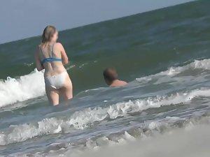 White bikini outlines her butt while she is in the waves Picture 8
