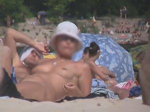 Zooming on hot nudist pussy on beach Picture 8