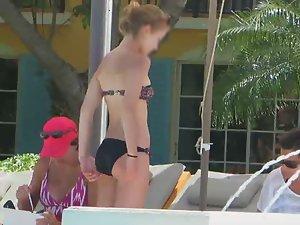 Teen rubs herself with lotion by the pool Picture 6
