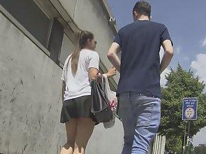 Upskirt of teen walking with boyfriend