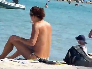 Mature topless woman spied on a beach Picture 4