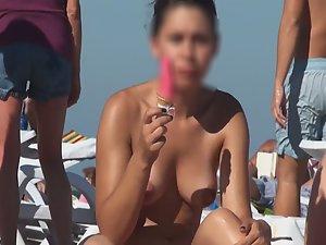 Topless chick eats an ice cream