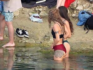 Delicate brunette and her tattooed friend in thong bikinis Picture 6
