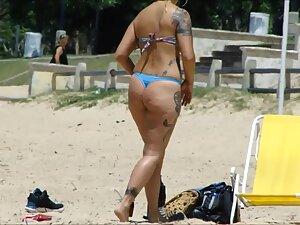 Tattooed girl's ass gets great shape when she crouches Picture 2