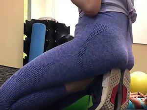 Tight ass of girl sitting on her feet in gym