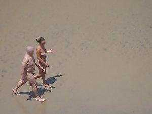 Zooming on weird nudist couple on beach Picture 7