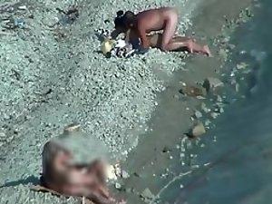 Two couples enjoying sex on a beach