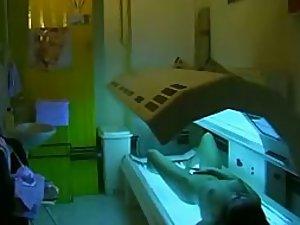 Teen girl fingers pussy during tanning