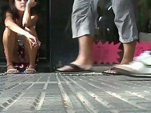 Peeping under sitting girl's skirt