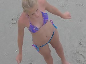 Teen in bikini flapping her arms