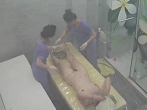 Spying on rich woman getting a four hand massage Picture 1