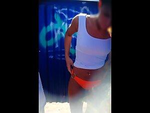 Voyeur peeps on a fuckable girl in beach cabin Picture 1